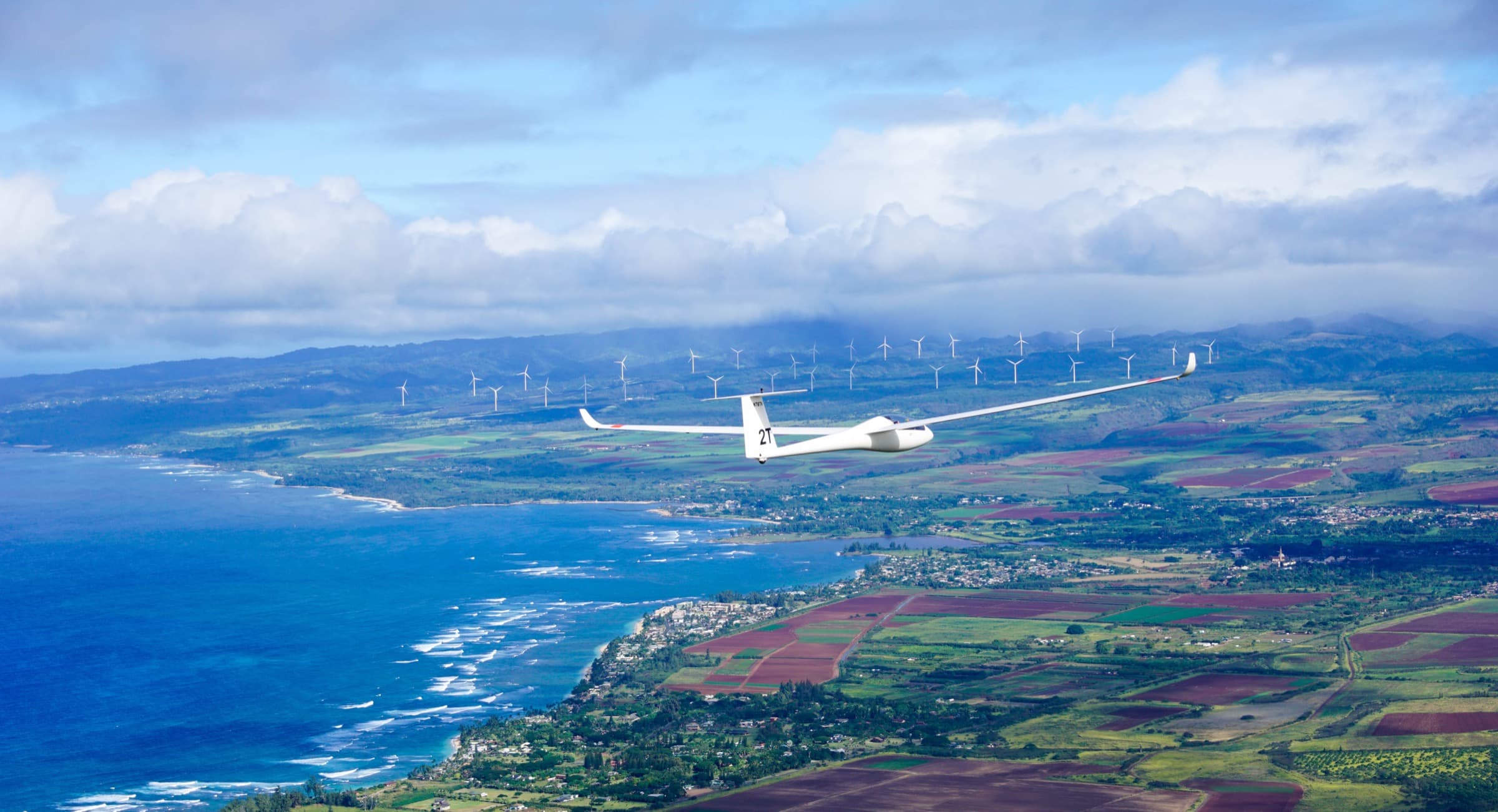 A sailplane riding the ridge lift above Mokulēʻia on Oʻahu's North Shore.