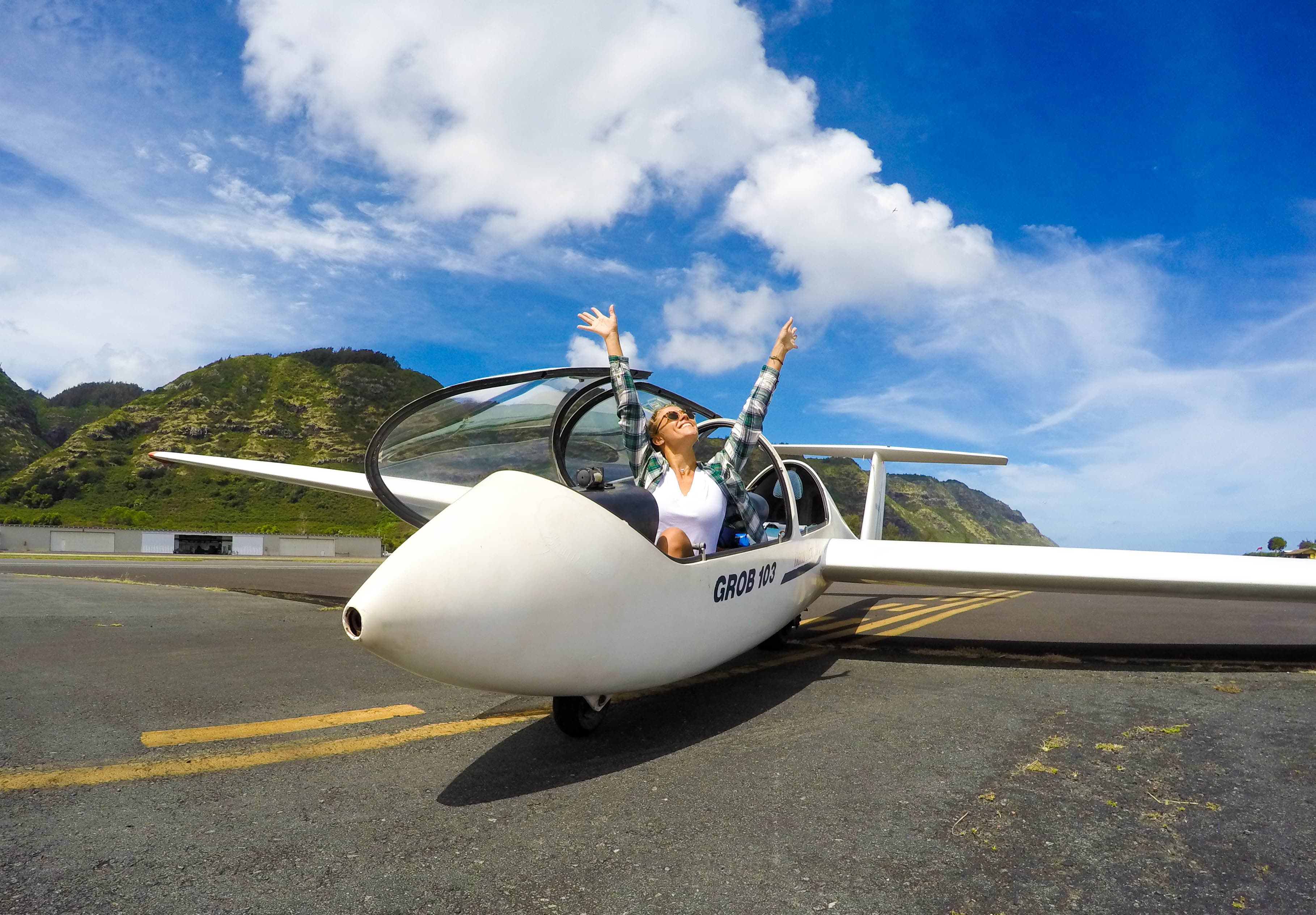 A young student grinning after a first glider flight.